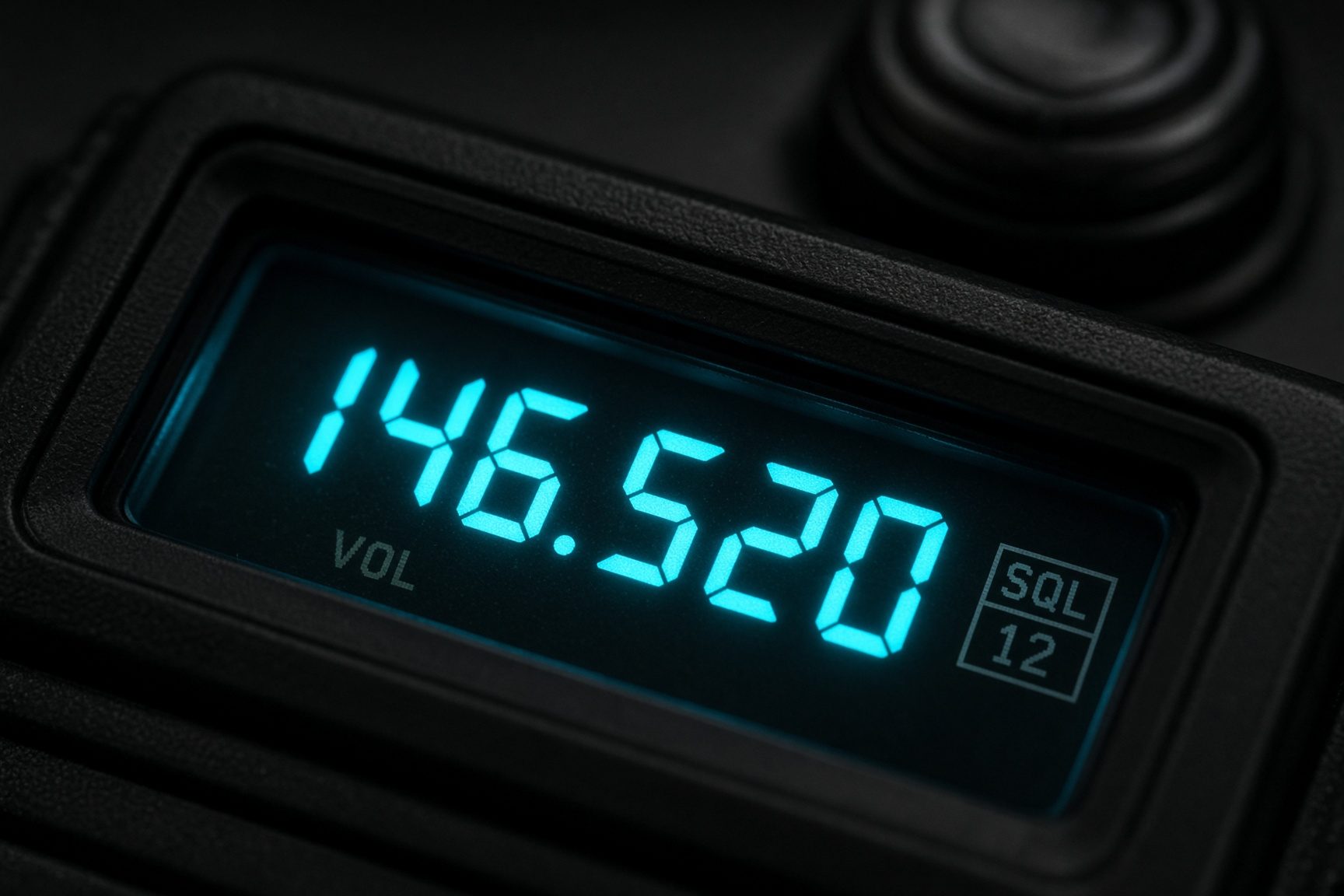 Close-up of a handheld ham radio display glowing in the dark
